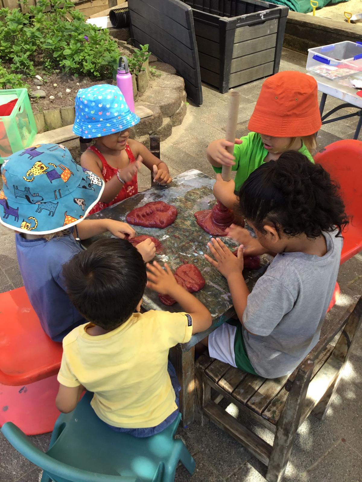 Child painting and creating art at Little Village Preschool